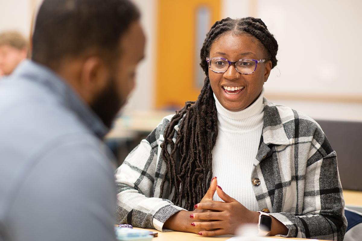 MPA student smiles at classmate.