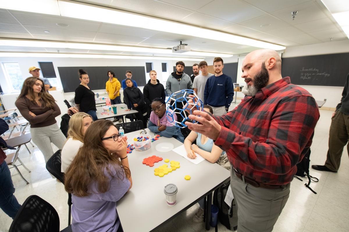 Alex Moore teaching students in a classroom