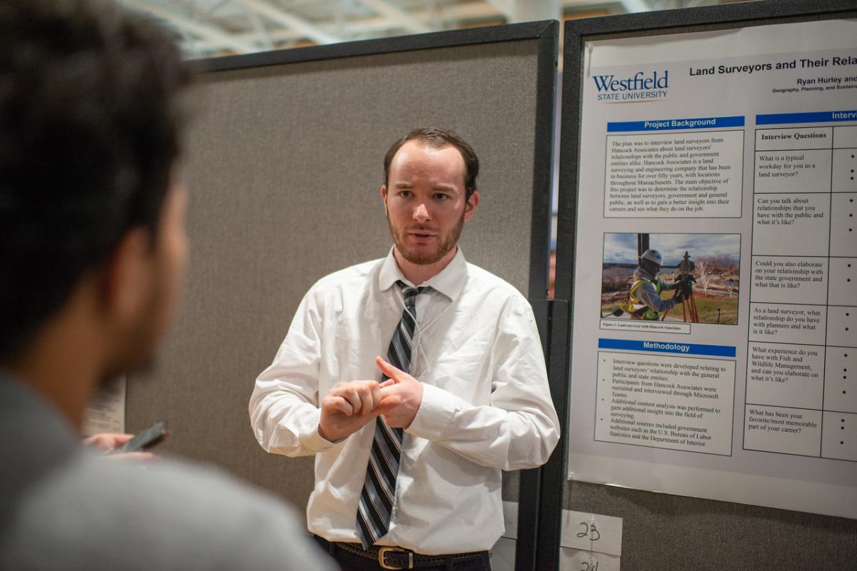 Urban and Regional Planning student giving presentation at undergraduate research event.