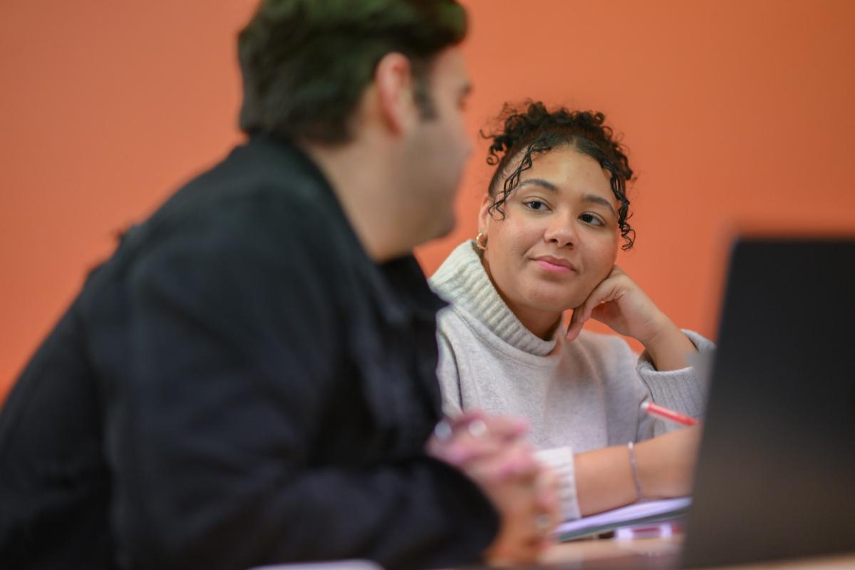 Student attentively listening to a classmate speaking.