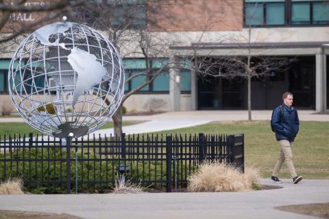 Student Walking past Globe