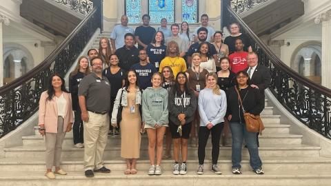 A photo of Charles DiStefano's state and local government class on the capital steps in Boston. The students pose as they explored the capital building and learned how legislation works in the culmination of their summer class.