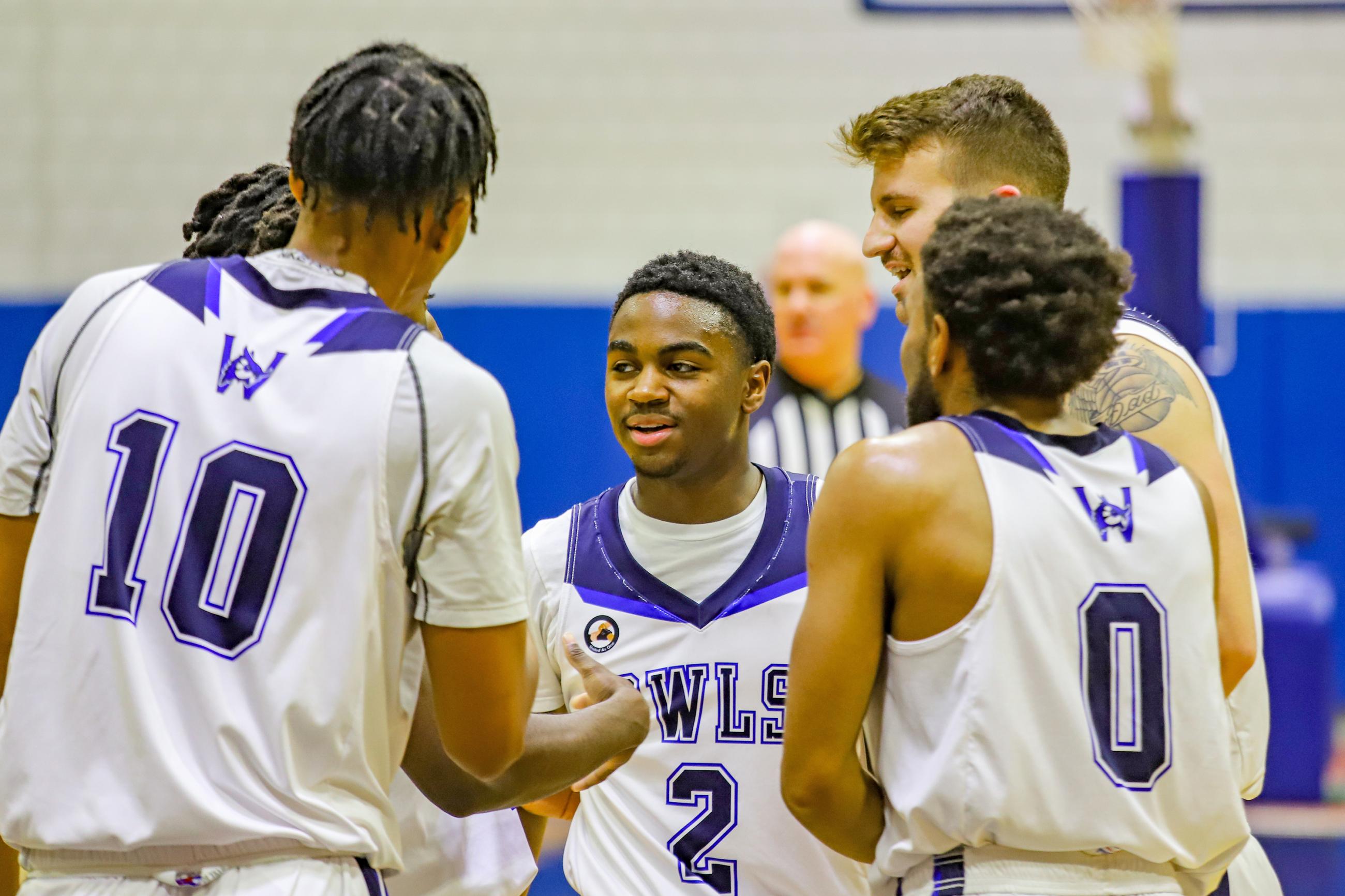 Members of the WSU Men's Basketball team gather together during a game at the Woodward Center