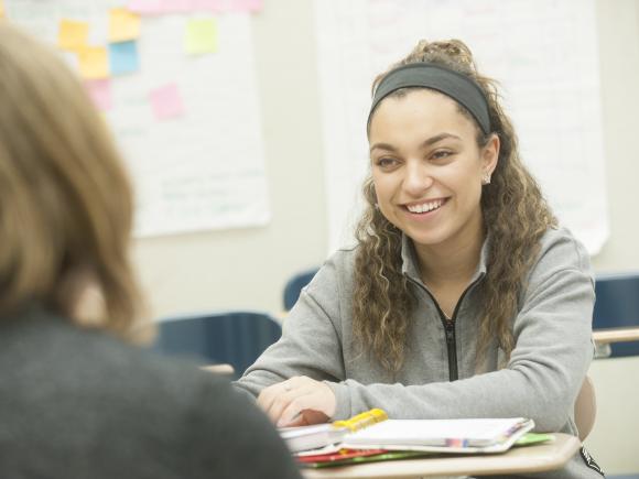 Image of female student smiling at classmate