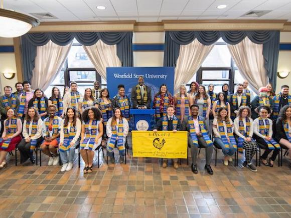 Students sit and pose with new Sankofa stoles.