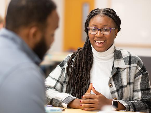 MPA student smiles at classmate 