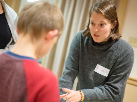 A student talks to a child.