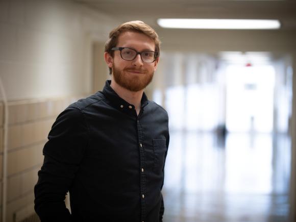 MSW Graduate Student Smiling in Academic Building Hallway