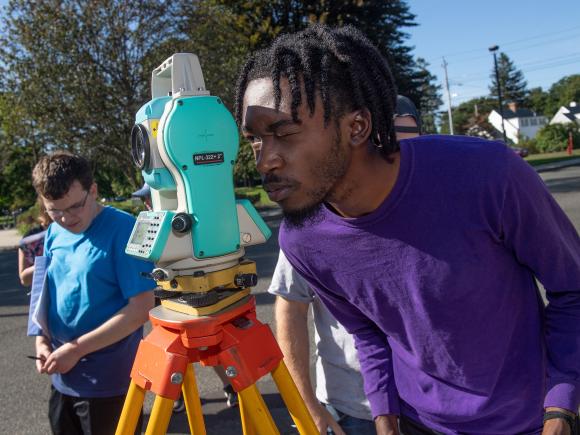 Westfield State Students survey a parking lot in town.