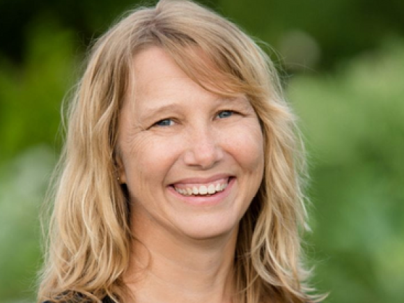 WMWP 2024 Speaker Anne Elrod Whitney smiling wearing black shirt with blonde shoulder length hair.