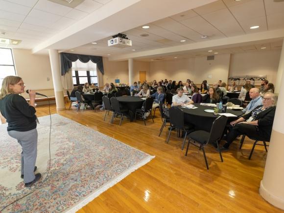 From the 2024 WMWP's Best Practices for Teachers conference. a speaker stands before rows of participants as she explains their agenda.