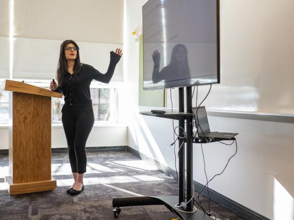 Student standing at podium giving a presentation.