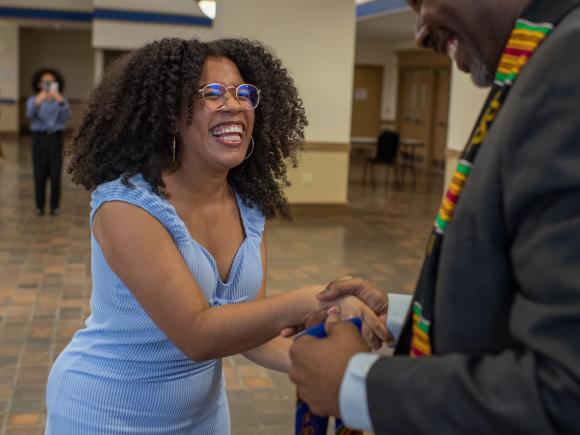 Education student shaking hands smiling.