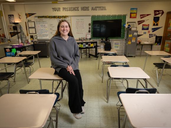 Education student smiling in a classroom during student teaching.