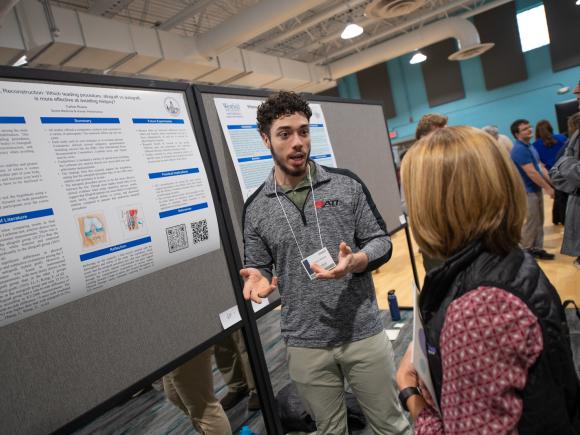 Student presenting research findings at the Undergraduate Research Conference.