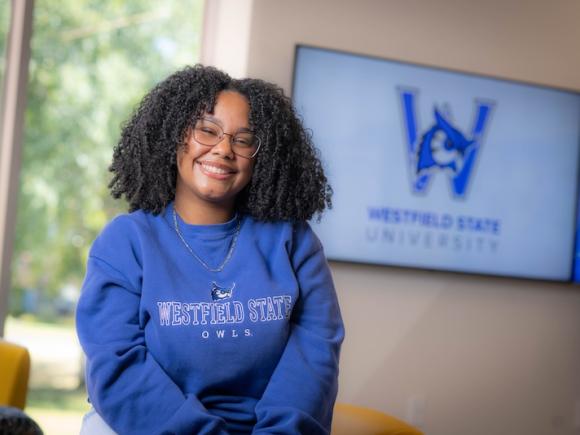 Dianyeliz Ozuna Sandoval, president of the Class of 2026. She's wearing a blue sweatshirt and poses in front of a white wall.