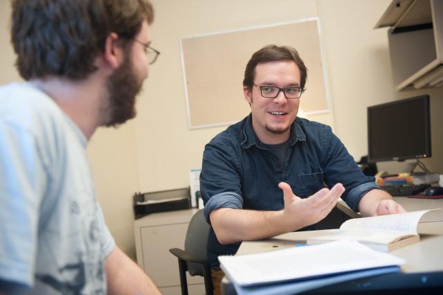 Westfield State English student works with another student in the Reading and Writing Center