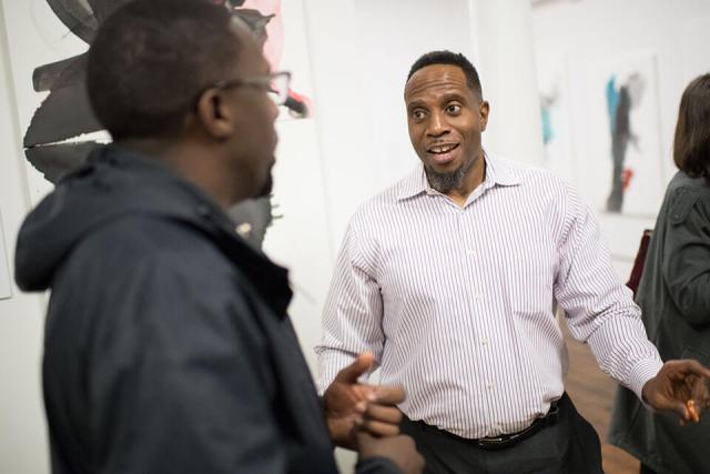 Art Department Professor Imo Imeh engages a student in conversation.