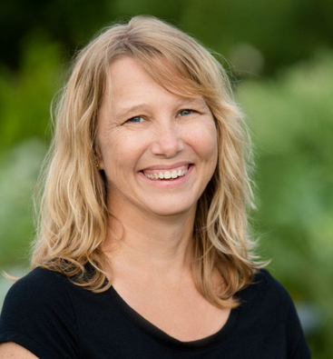 WMWP 2024 Speaker Anne Elrod Whitney smiling wearing black shirt with blonde shoulder length hair.