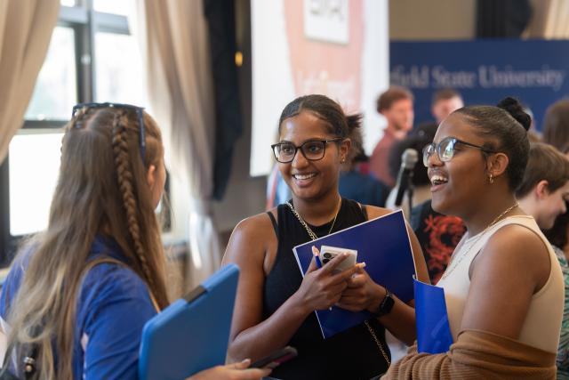 Students talking in a group at New Student Orientation.