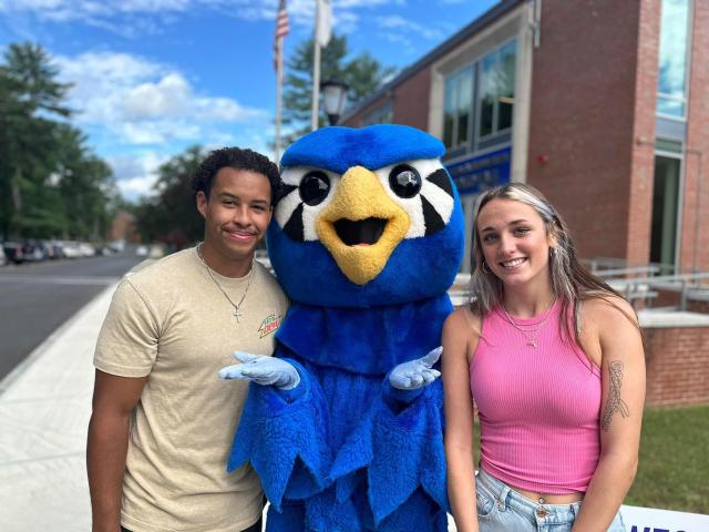 New Student Orientation with two students smiling with Nestor.