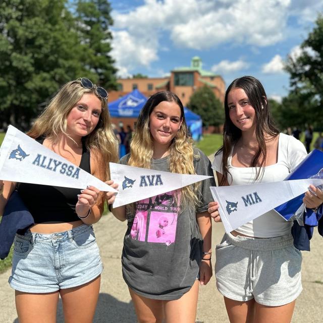 New Student Orientation with students holding WSU pennant flags.