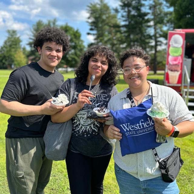 New Student Orientation with group of students smiling eating ice cream.