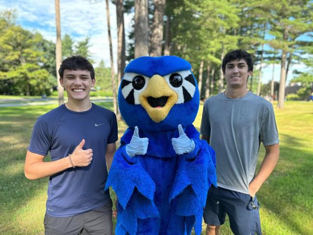 Two students smiling with Nestor.