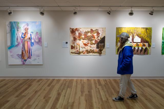Student in Arno Maris Gallery on campus looking at artwork.
