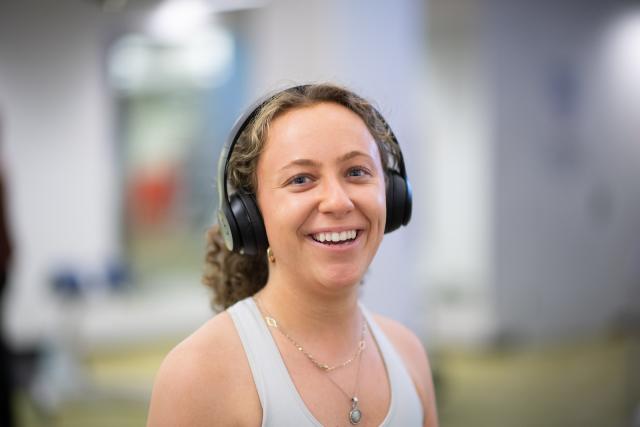 Student smiling while exercising in the fitness center.