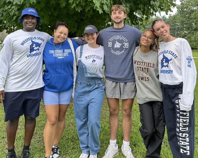 Group of Westfield State University students smiling and wearing Westfield State apparel.