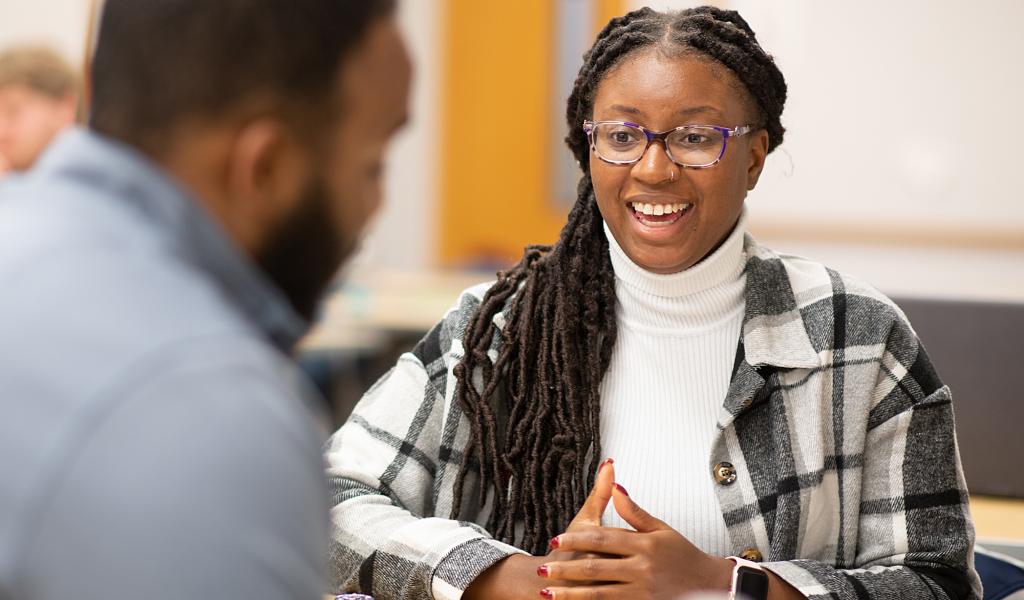 MPA student smiles at classmate 