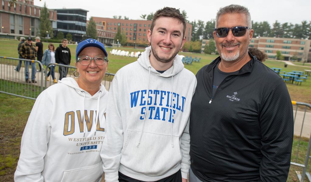 Families & Champions Weekend 2023 featuring a family of 3 smiling wearing WSU shirts.