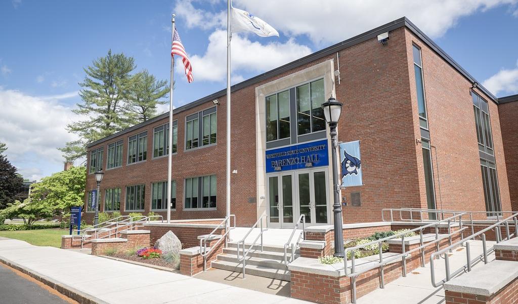 Exterior of Parenzo Hall with owl flag on light post.