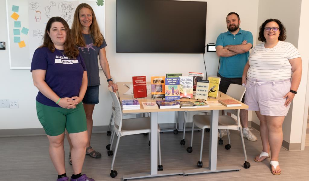 Summer Leadership Institute group photo with books on center table.