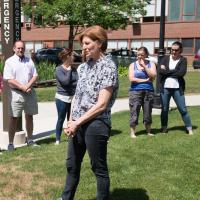 Professor Tarin Weiss outside speaking to group.