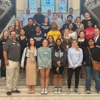 A photo of Charles DiStefano's state and local government class on the capital steps in Boston. The students pose as they explored the capital building and learned how legislation works in the culmination of their summer class.